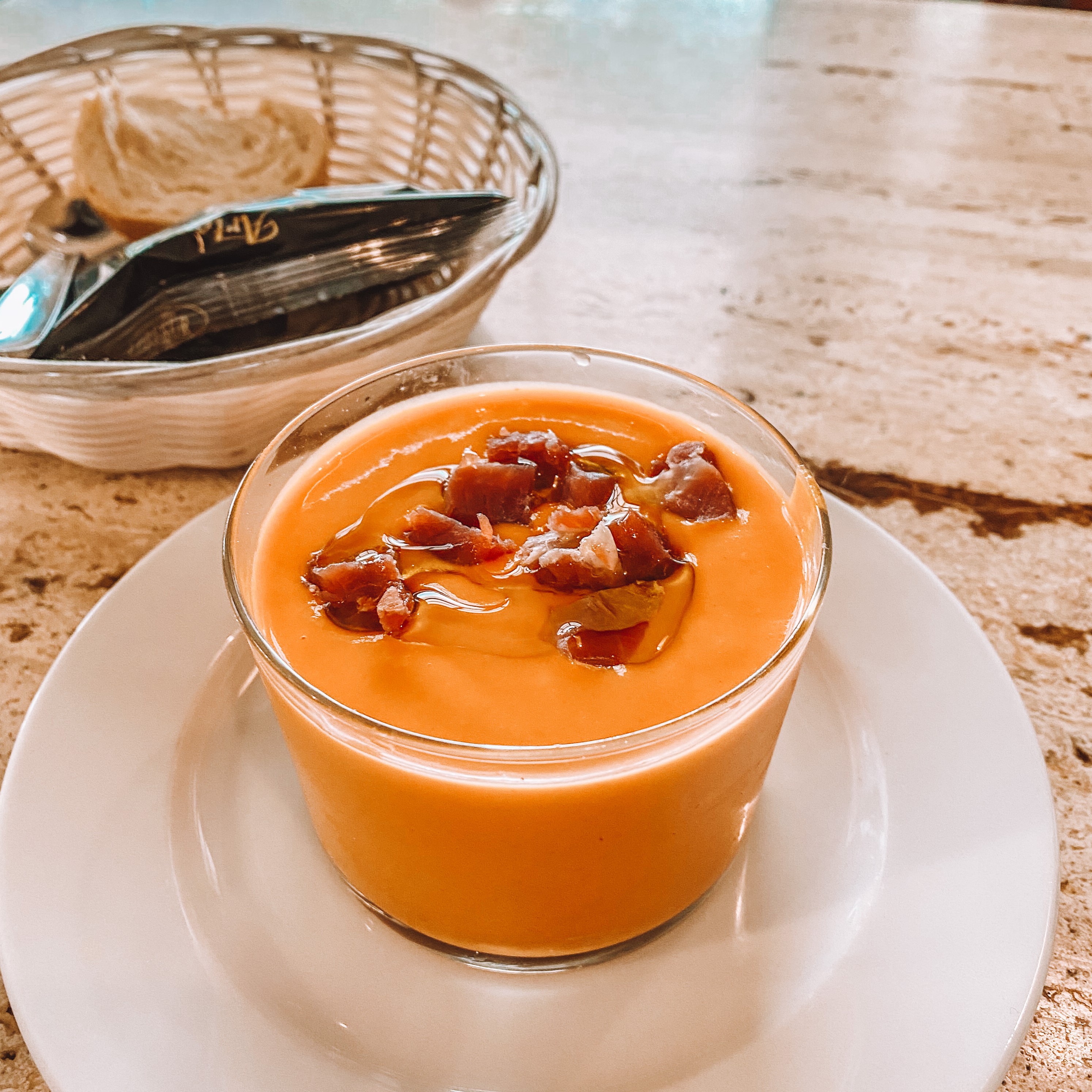 Creamy bowl of salmorejo with Spanish olive oil and jamon