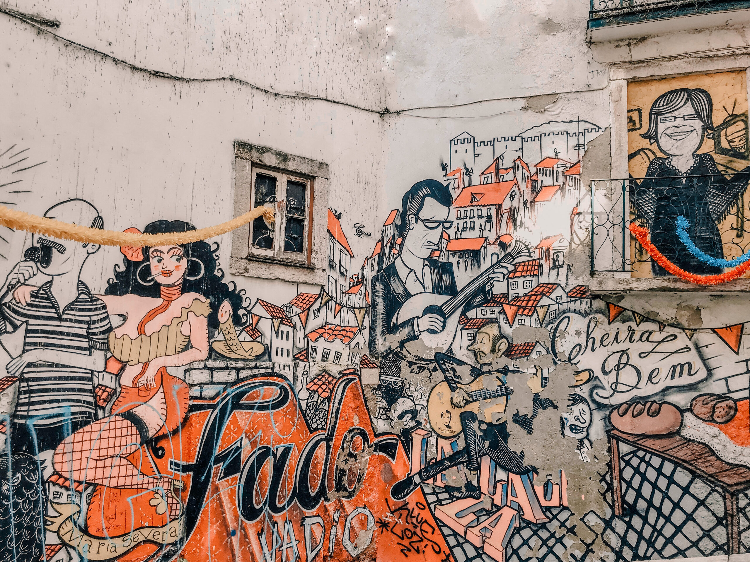 Escadinhas de São Cristóvão. Graffiti mural with fado players and Portuguese buildings.
