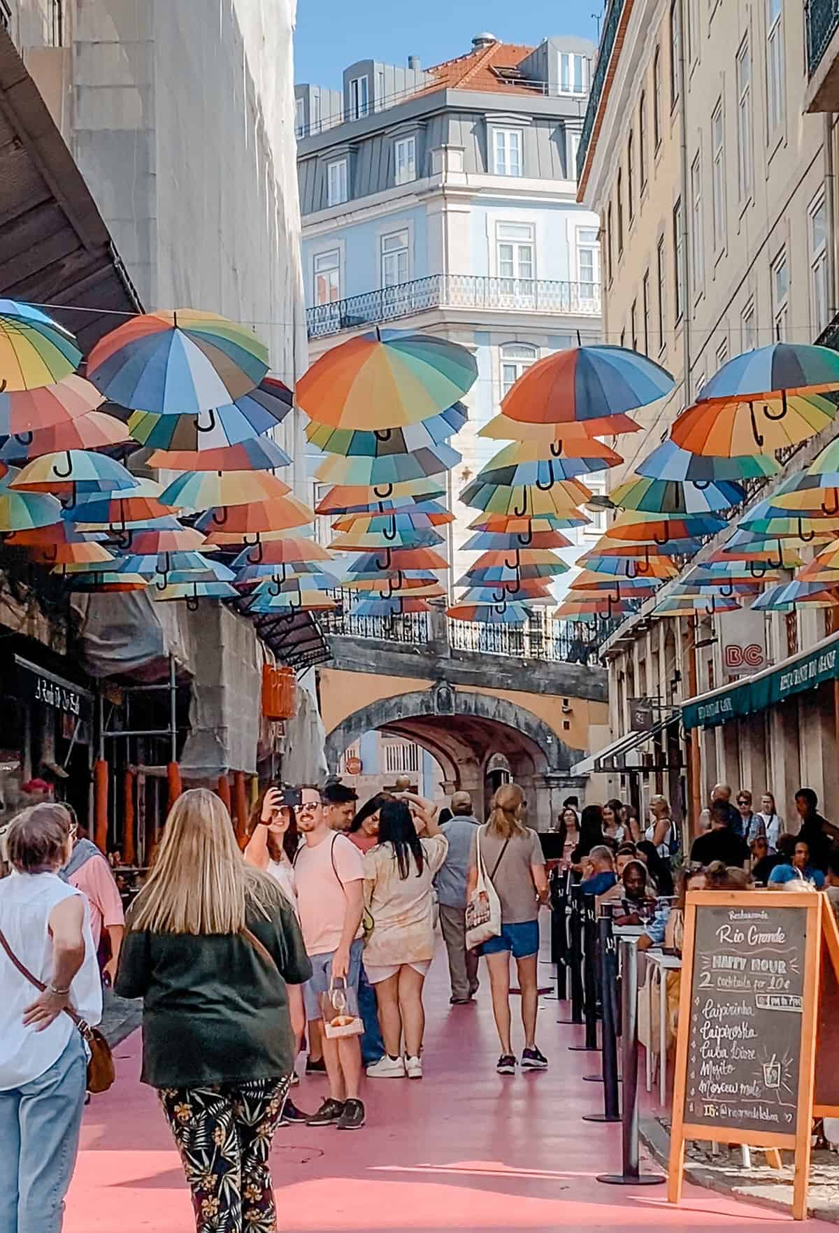Colorful umbrellas on pink street.