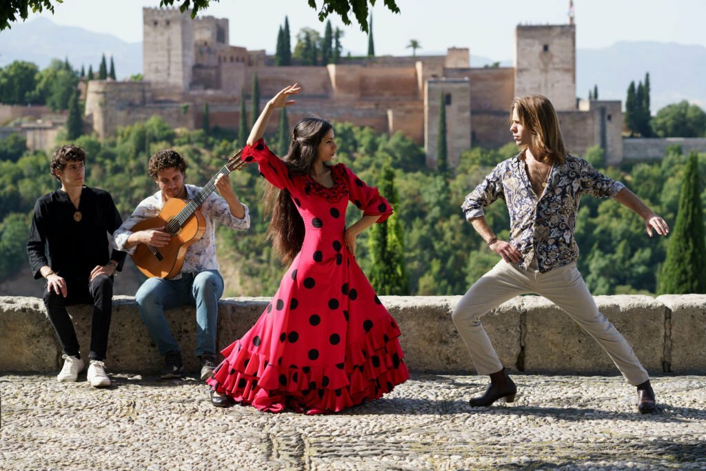flamenco dancers and musicians putting on outdoor performance