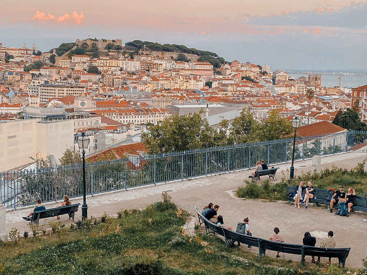 Miradouro de São Pedro de Alcântara. A view of the sunset, rooftops and Taugus River.