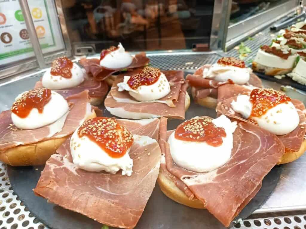 jamon and cheese tostas served on a platter outdoors